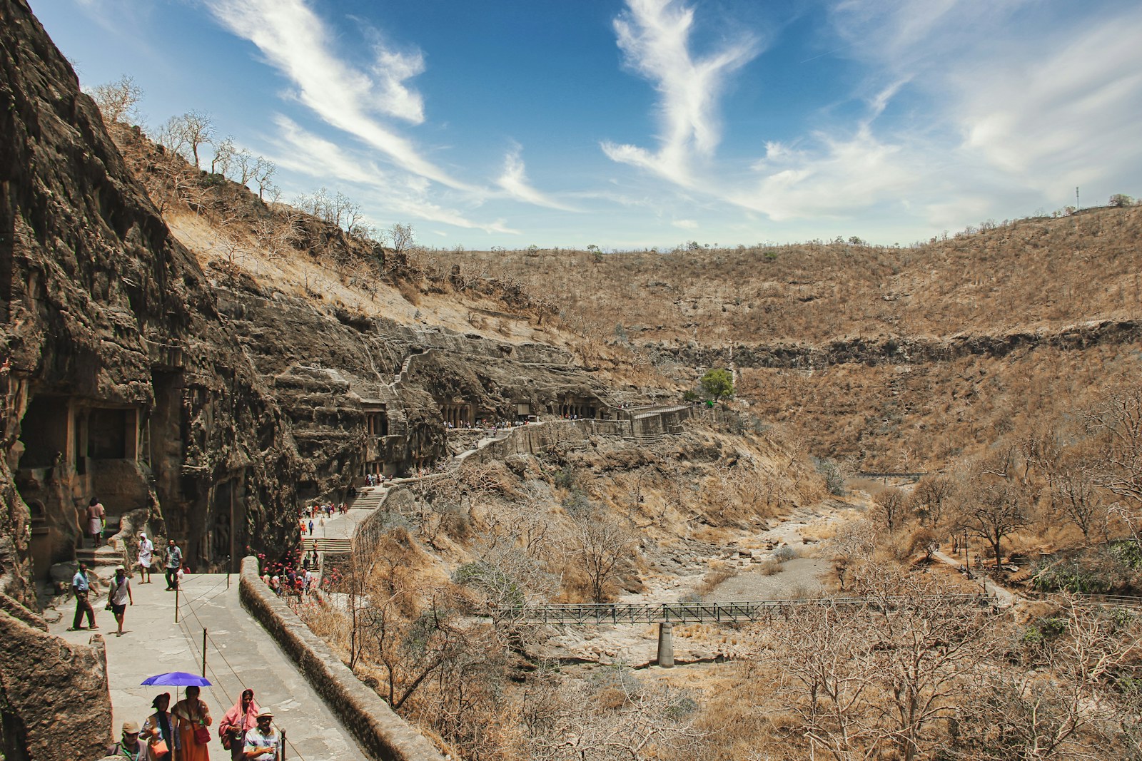 Visitors on the path beside the rock-cut caves at Ajanta