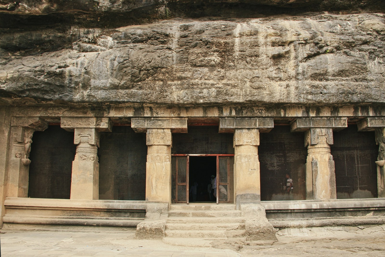 Rock-cut columns and a cave entrance at Ellora